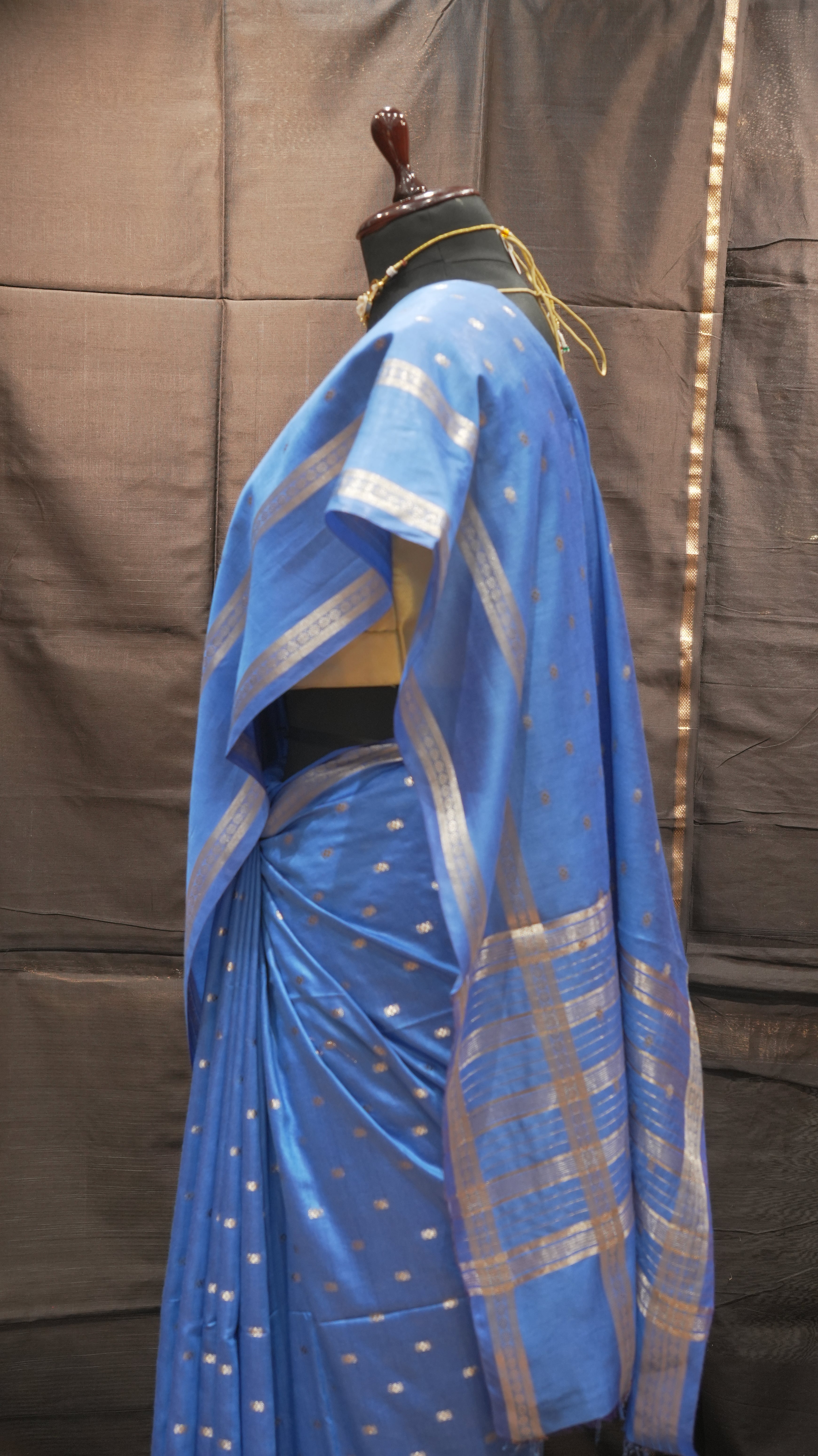 Blue fabric with gold patterns on a dark background