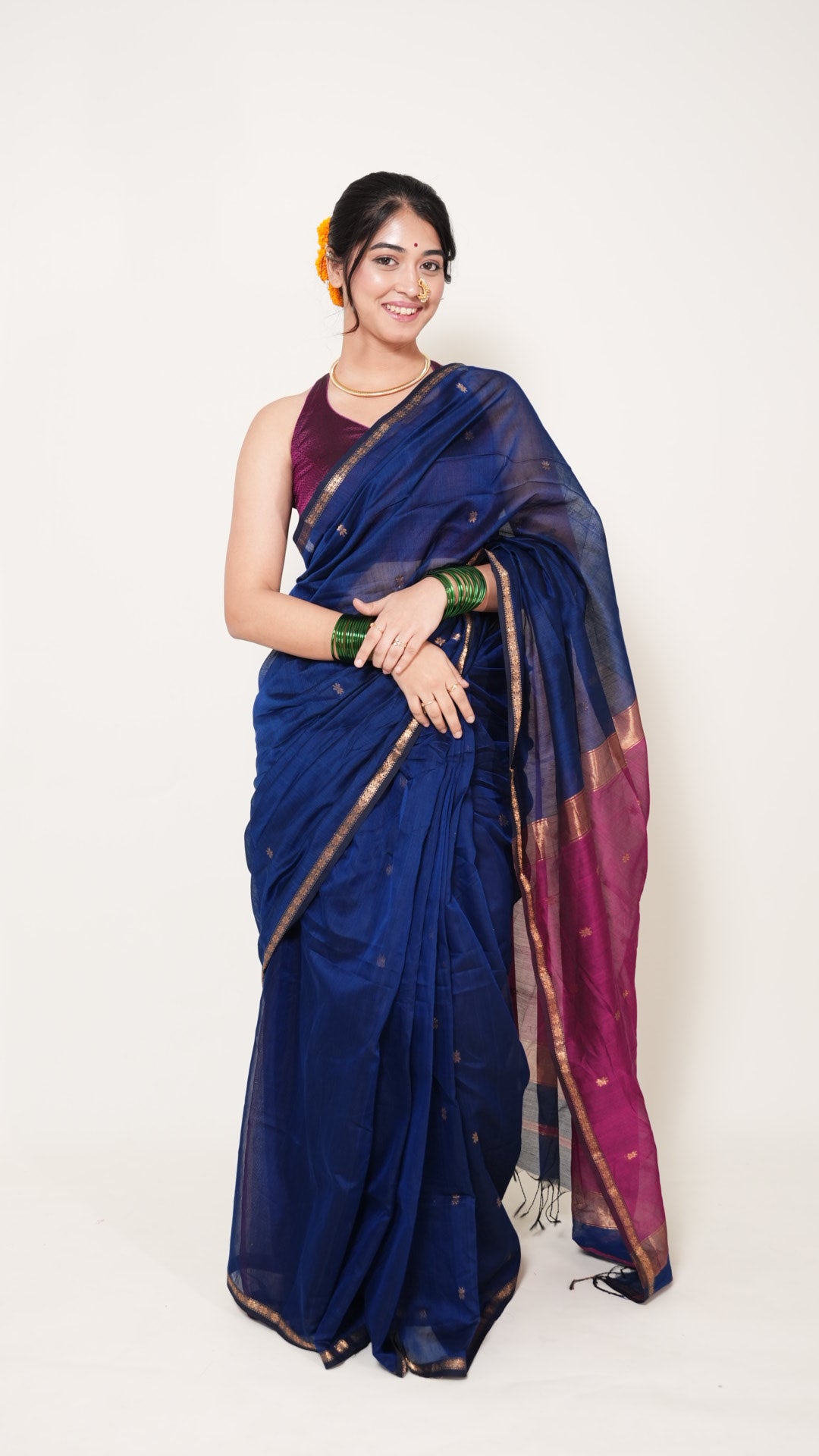 Woman wearing a blue saree with a white background