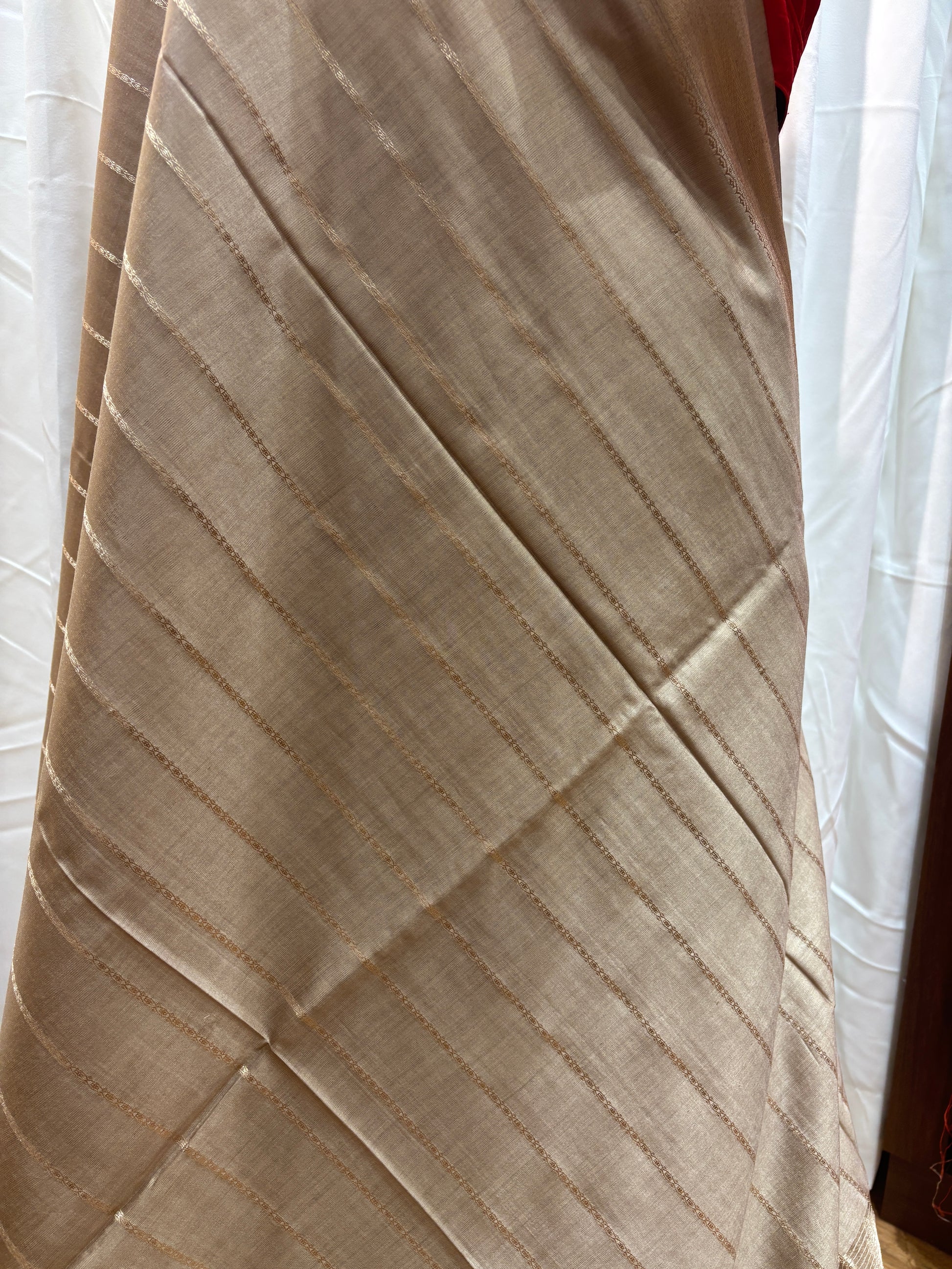Beige quilted mattress cover on a bed