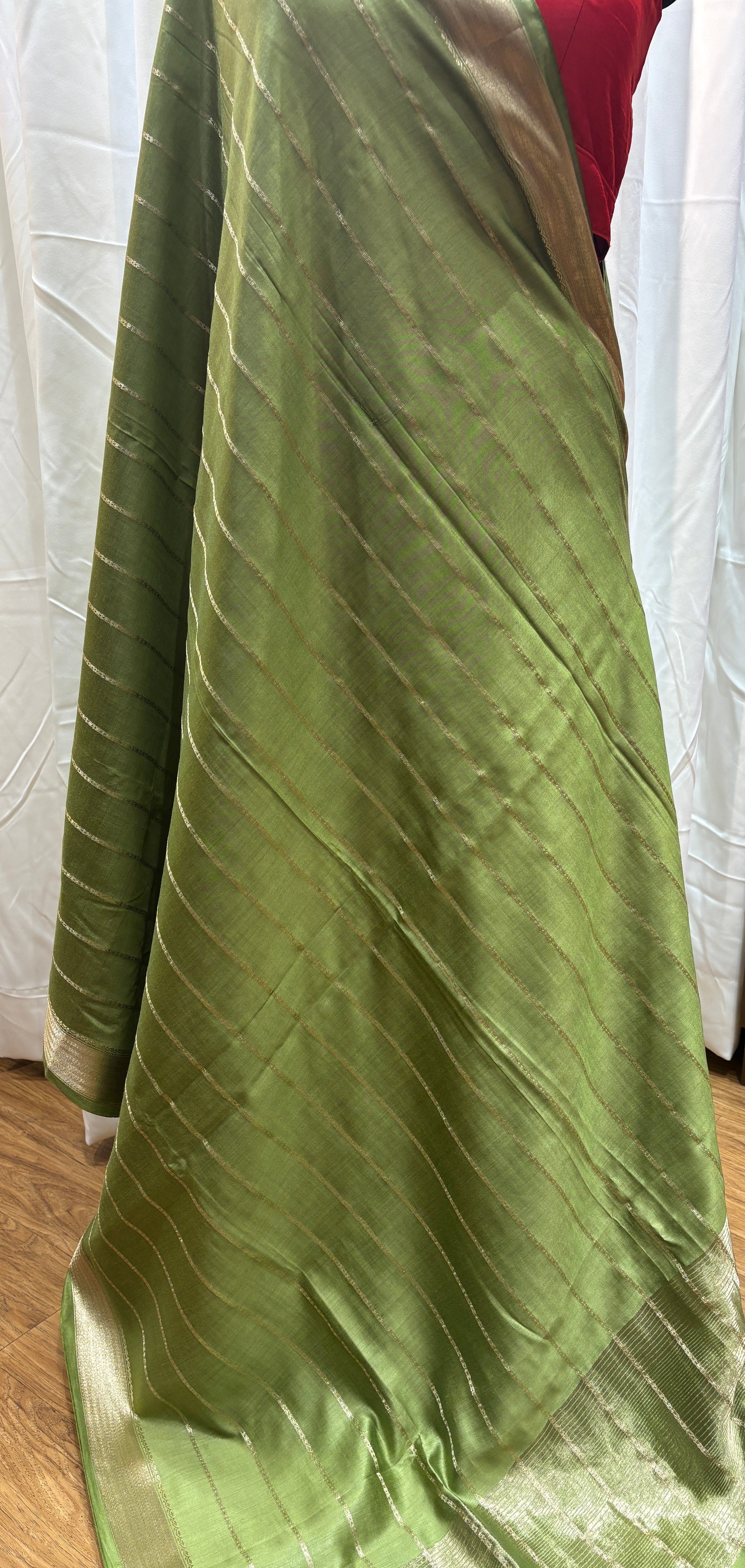 Green fabric draped over a surface with a blurred background